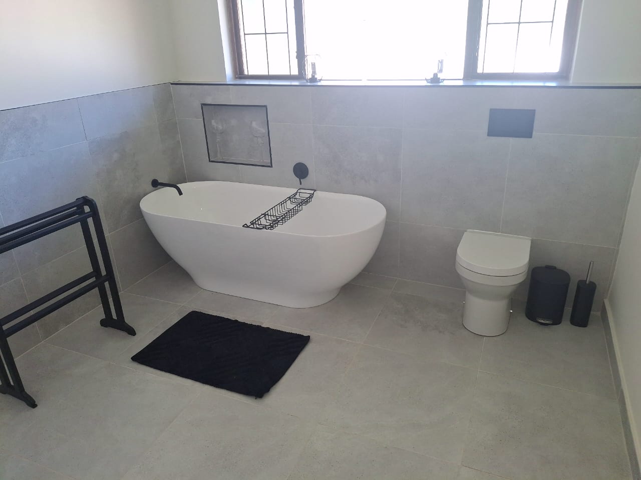 Freestanding bath and tiled wall in a Durban bathroom renovation