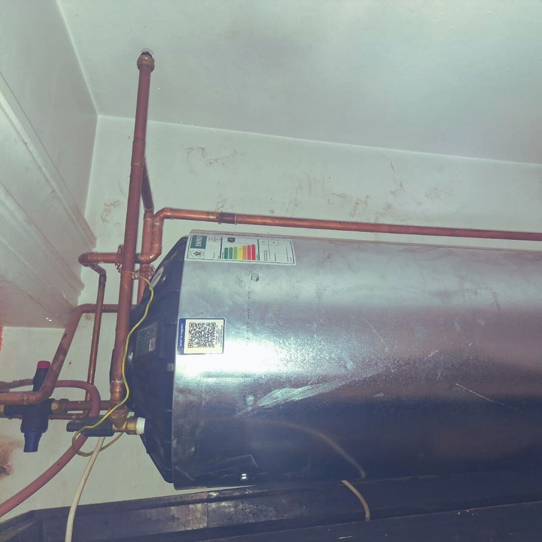 Electric geyser with neat copper pipework installed in a Durban ceiling
